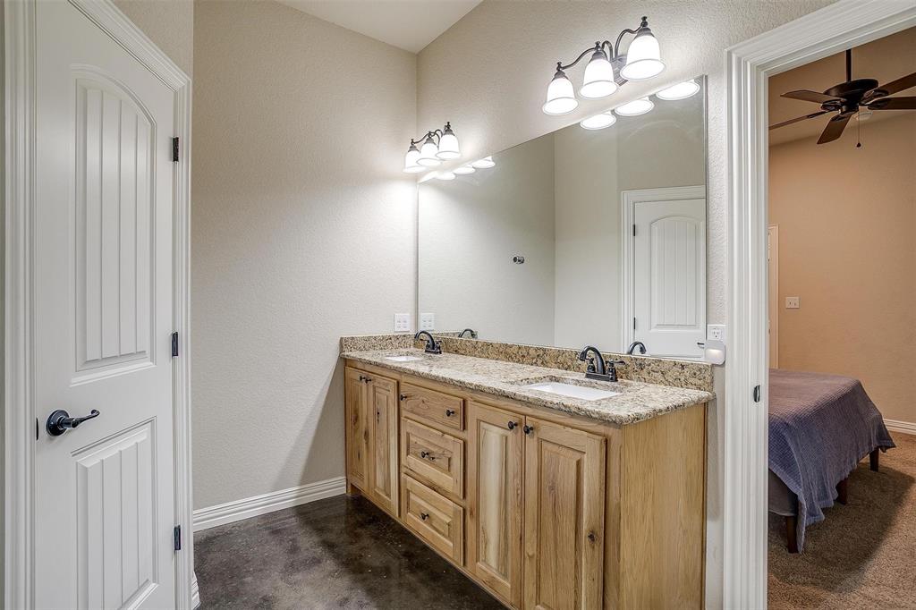 505 N Avenue East Springtown, TX 76082 - Photo 18 of 27 a bathroom with a double vanity sink and a mirror