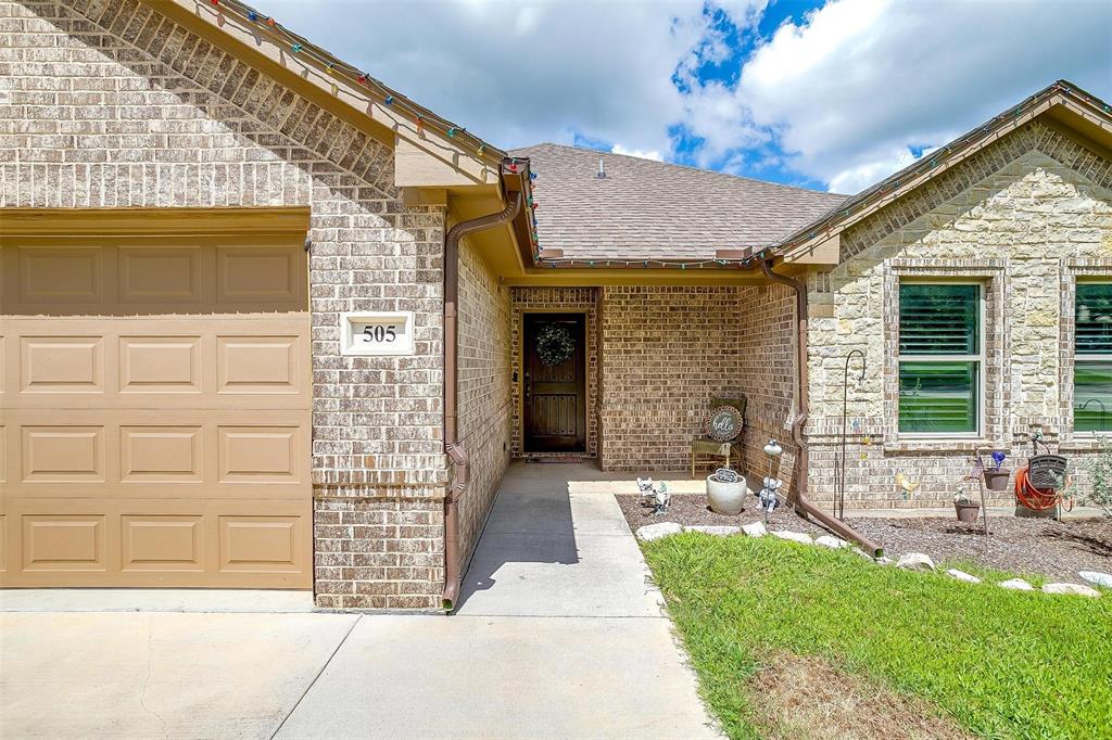 505 N Avenue East Springtown, TX 76082 - Photo 2 of 27 a front view of a house with garden