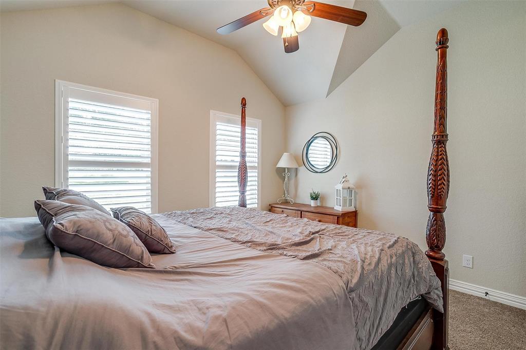 505 N Avenue East Springtown, TX 76082 - Photo 22 of 27 a bedroom with a bed and a chandelier