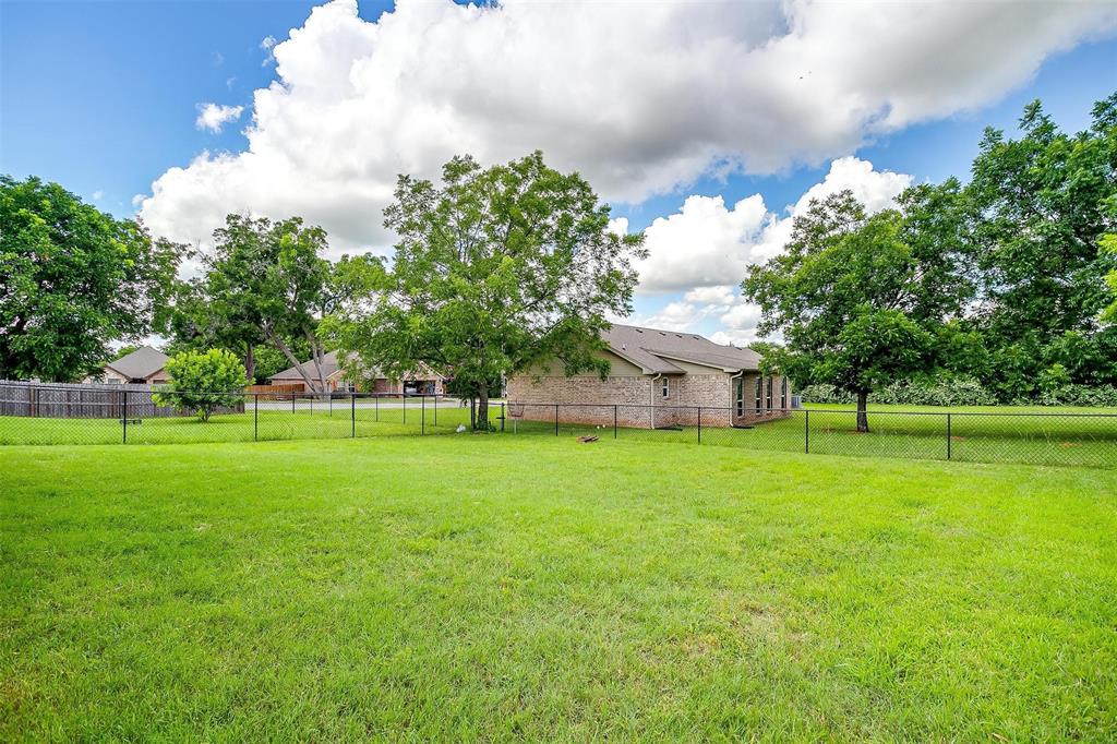 505 N Avenue East Springtown, TX 76082 - Photo 27 of 27 a view of a house with a big yard and a large tree