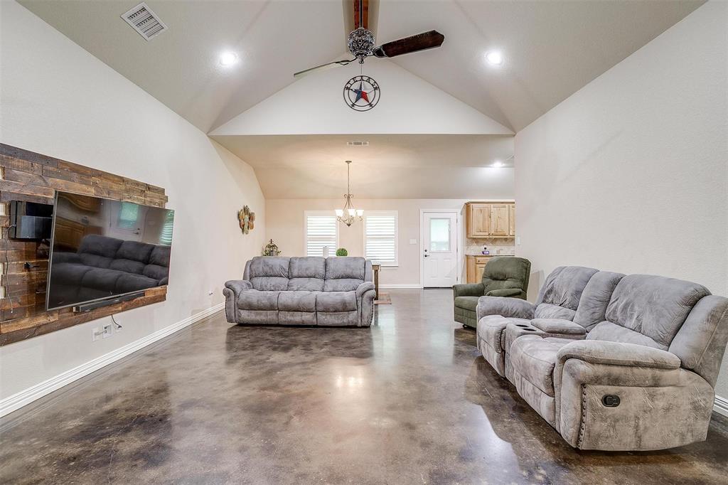505 N Avenue East Springtown, TX 76082 - Photo 7 of 27 a living room with furniture and a flat screen tv