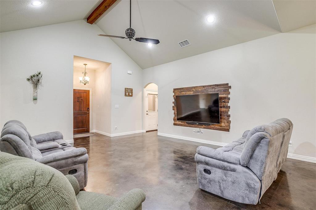 505 N Avenue East Springtown, TX 76082 - Photo 8 of 27 a living room with furniture and a flat screen tv