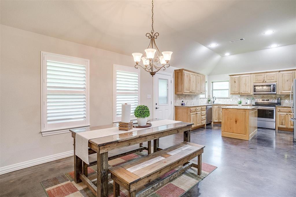 505 N Avenue East Springtown, TX 76082 - Photo 10 of 27 a dining room with wooden floor and kitchen view