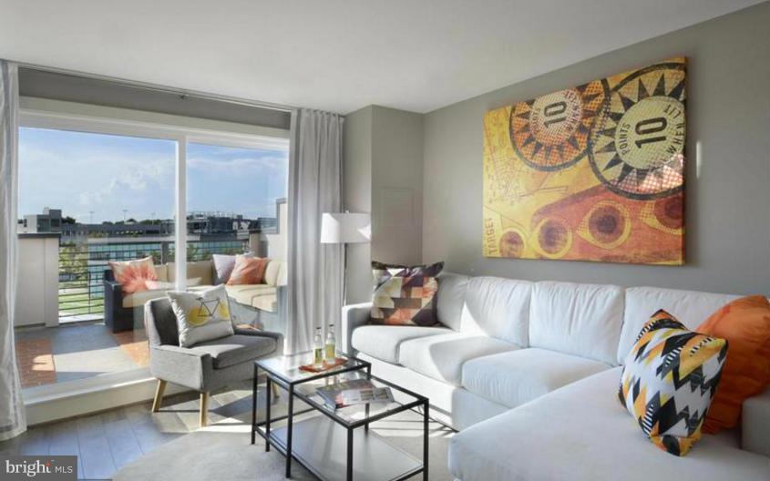 6680 Eames Way Bethesda, MD 20817 - Photo 13 of 19 a living room with furniture and a large window with outer view
