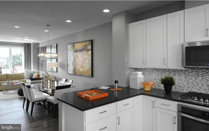 6680 Eames Way Bethesda, MD 20817 - Photo 4 of 19 a kitchen with a sink cabinets and window