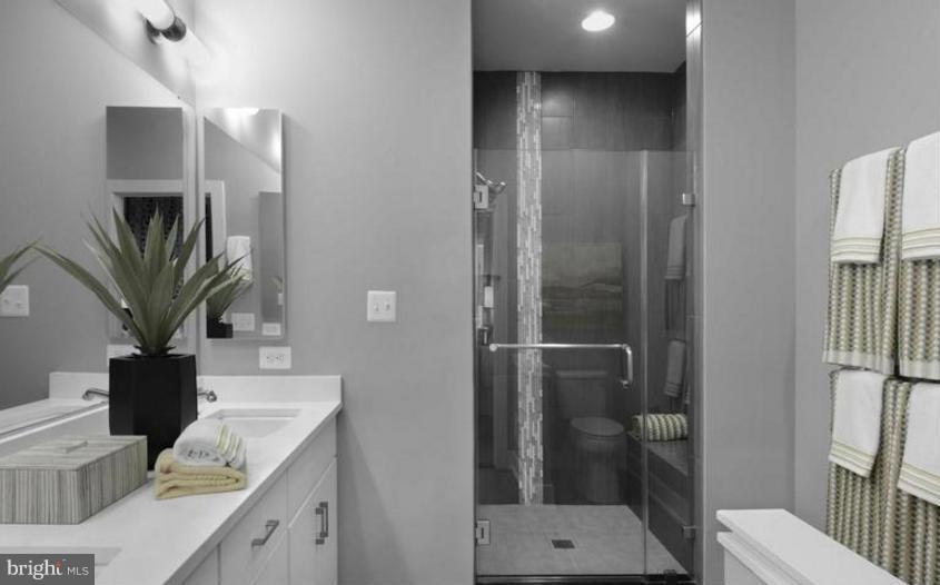 6680 Eames Way Bethesda, MD 20817 - Photo 9 of 19 a bathroom with a sink a toilet and shower