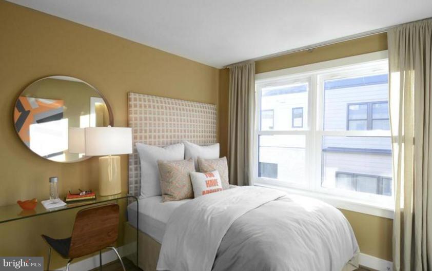 6680 Eames Way Bethesda, MD 20817 - Photo 10 of 19 a bedroom with a bed and a mirror