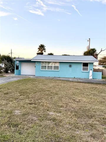 a view of a house with a backyard