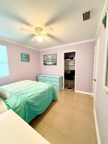 a bedroom with a bed and a ceiling fan