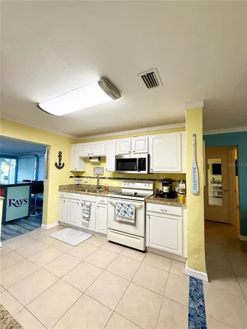 a kitchen with stainless steel appliances granite countertop a sink and cabinets