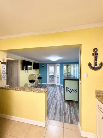 a view of a kitchen with a sink and a refrigerator