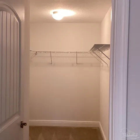a bathroom with a granite countertop sink and a toilet