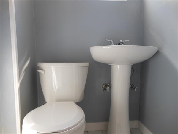 24 Benz Street Springfield, MA 01118 - Photo 11 of 21 a white toilet sitting next to a white sink