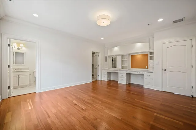 a bathroom with a toilet a sink a mirror a bathtub and vanity