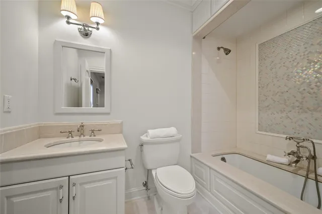 a room with stainless steel appliances wooden floors and large window