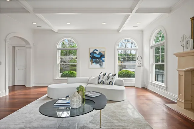 a living room with furniture windows and wooden floor