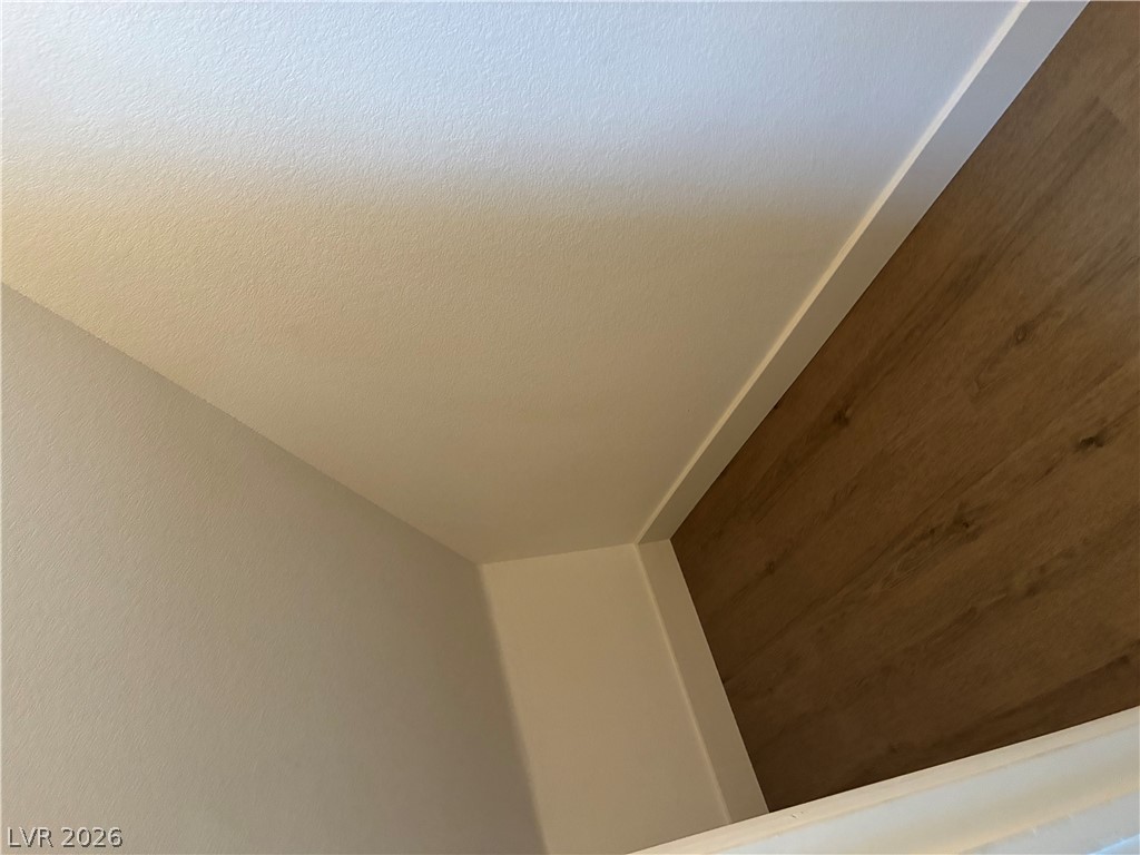 7727 Pista Way Las Vegas, NV 89179 - Photo 6 of 12 Premium wood-look flooring and crisp white walls define this inviting interior corner.