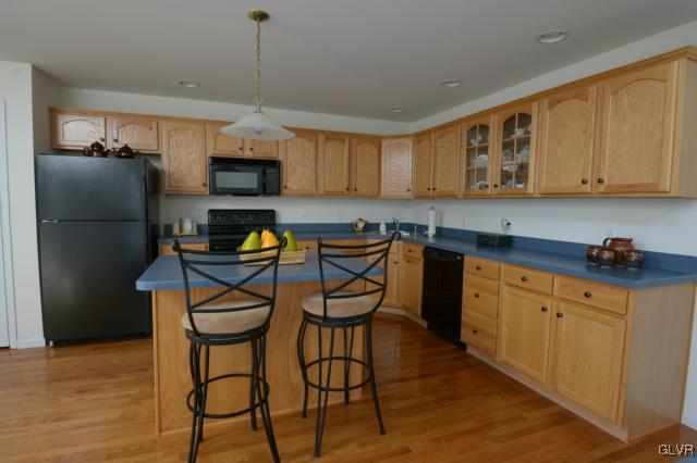 4140 Walter Road Bethlehem, PA 18020 - Photo 3 of 21 a kitchen with stainless steel appliances granite countertop a refrigerator a sink dishwasher a stove a microwave oven with white cabinets and wooden floor