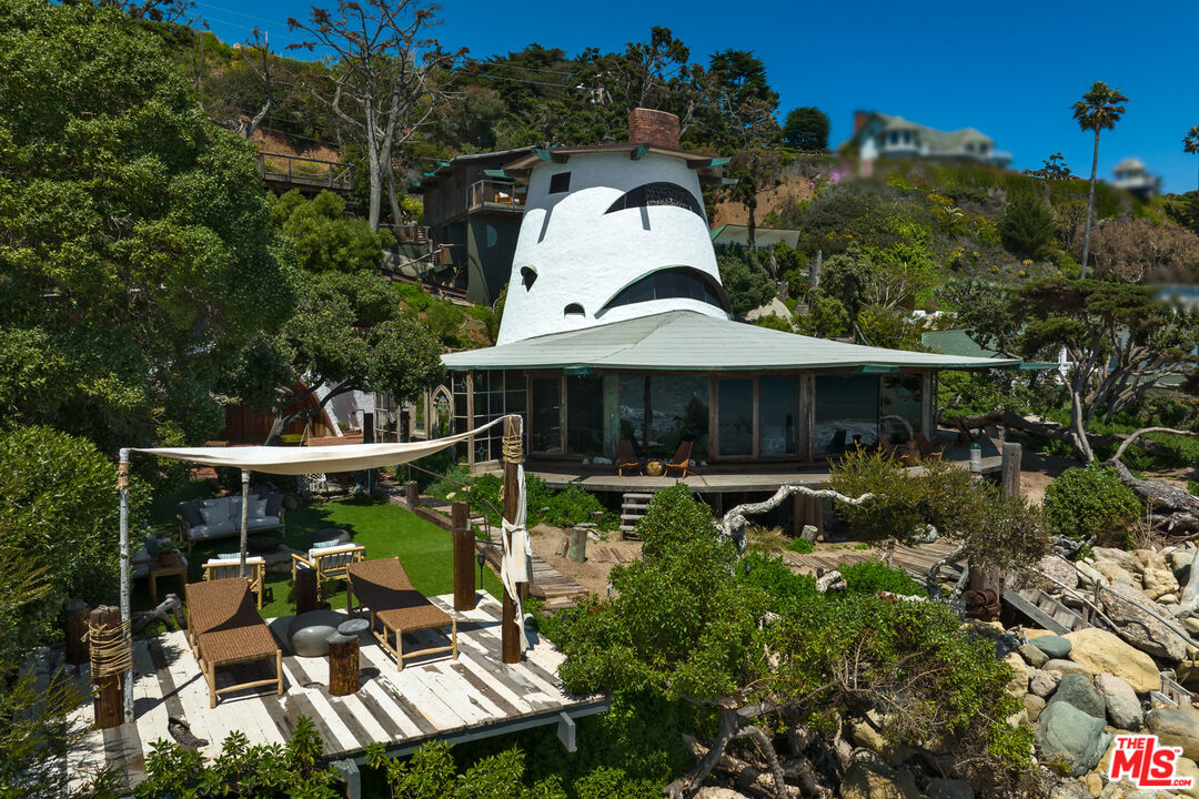 33604 Pacific Coast Highway Malibu, CA 90265 - Photo 2 of 46 a backyard of a house with wooden floor and outdoor seating