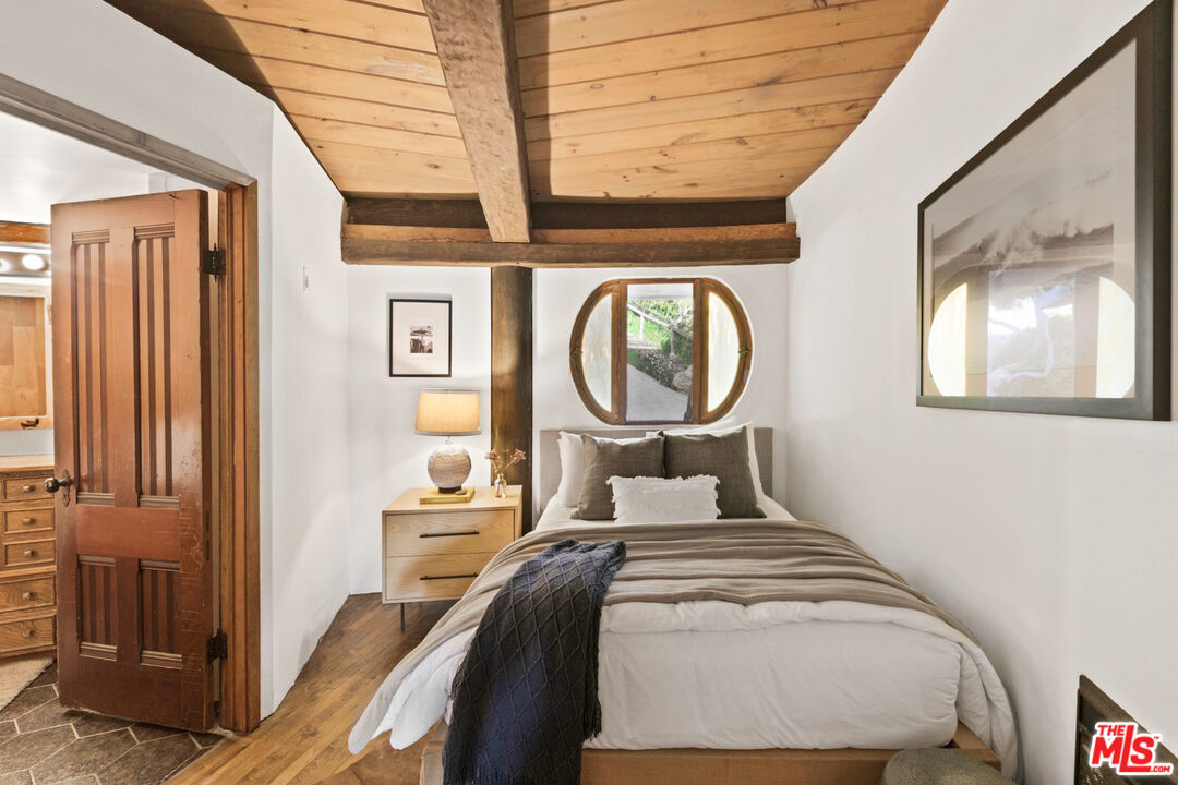 33604 Pacific Coast Highway Malibu, CA 90265 - Photo 21 of 46 a bedroom with a bed and a mirror