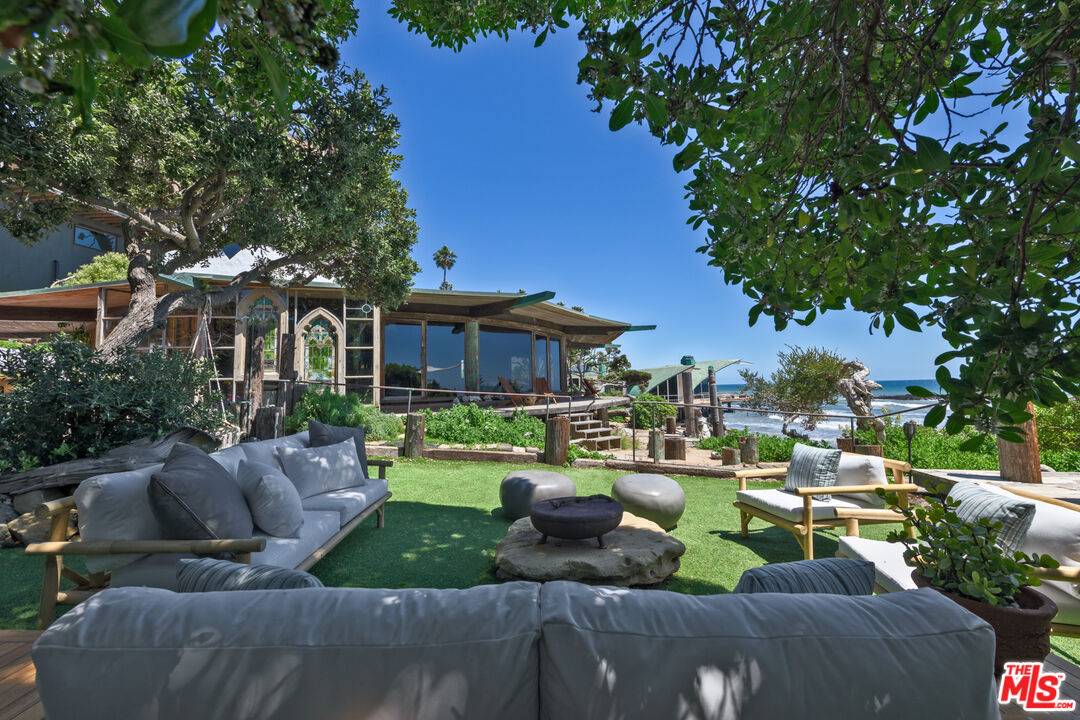 33604 Pacific Coast Highway Malibu, CA 90265 - Photo 25 of 46 a view of a house with backyard sitting area and swimming pool