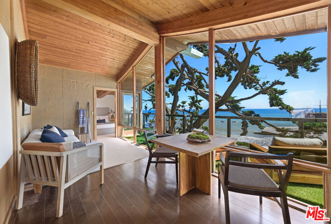 33604 Pacific Coast Highway Malibu, CA 90265 - Photo 28 of 46 a dining room with furniture and wooden floor