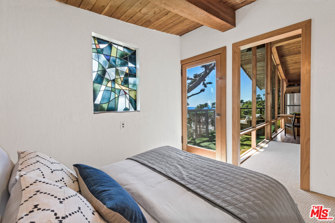 33604 Pacific Coast Highway Malibu, CA 90265 - Photo 29 of 46 a bedroom with a bed and a large window with outer view