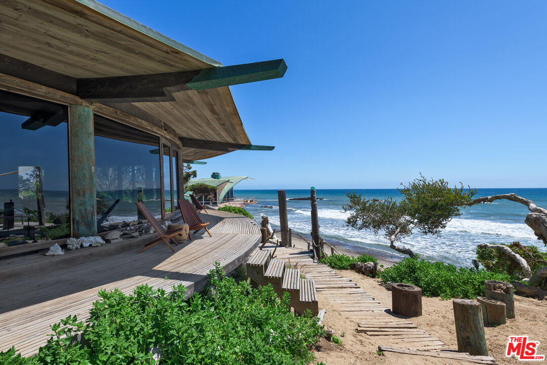 33604 Pacific Coast Highway Malibu, CA 90265 - Photo 6 of 46 a view of a patio with table and chairs potted plants