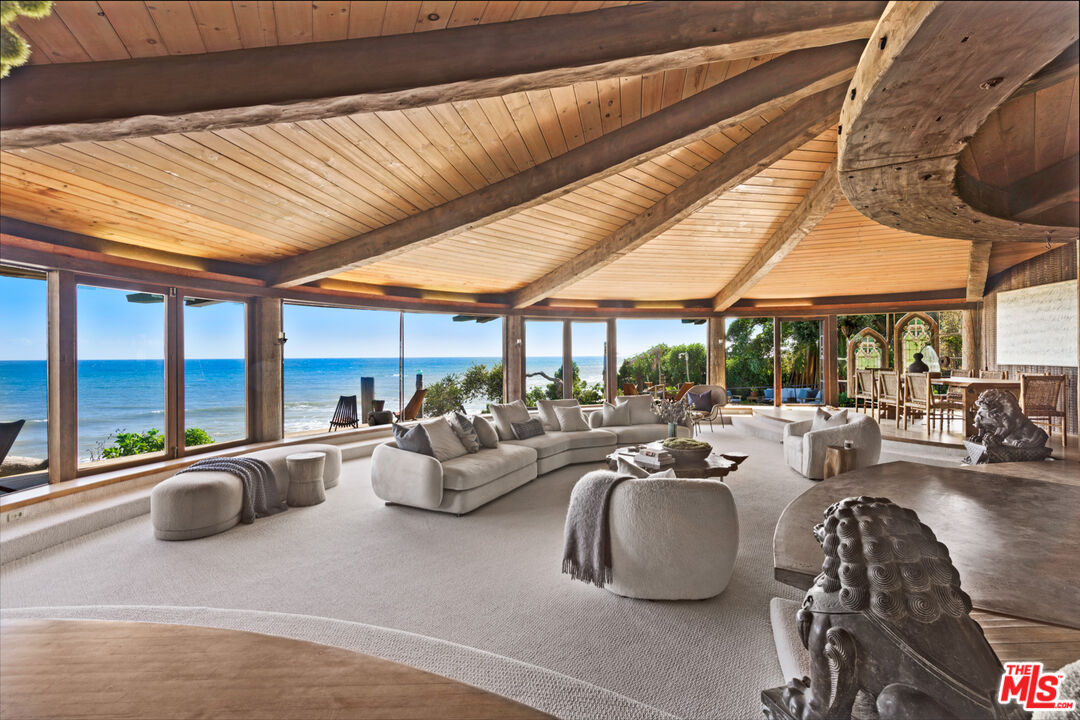 33604 Pacific Coast Highway Malibu, CA 90265 - Photo 9 of 46 a living room with patio furniture and floor to ceiling windows