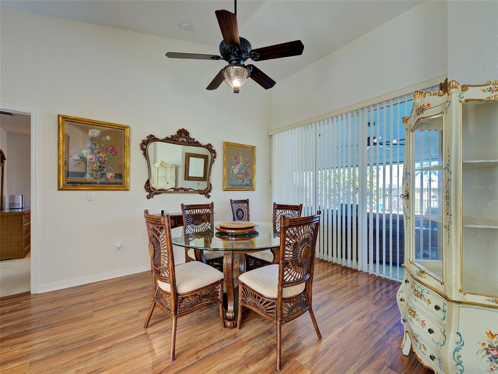77 Medalist Road Rotonda West, FL 33947 - Photo 12 of 81 a view of a dining room with furniture window and wooden floor