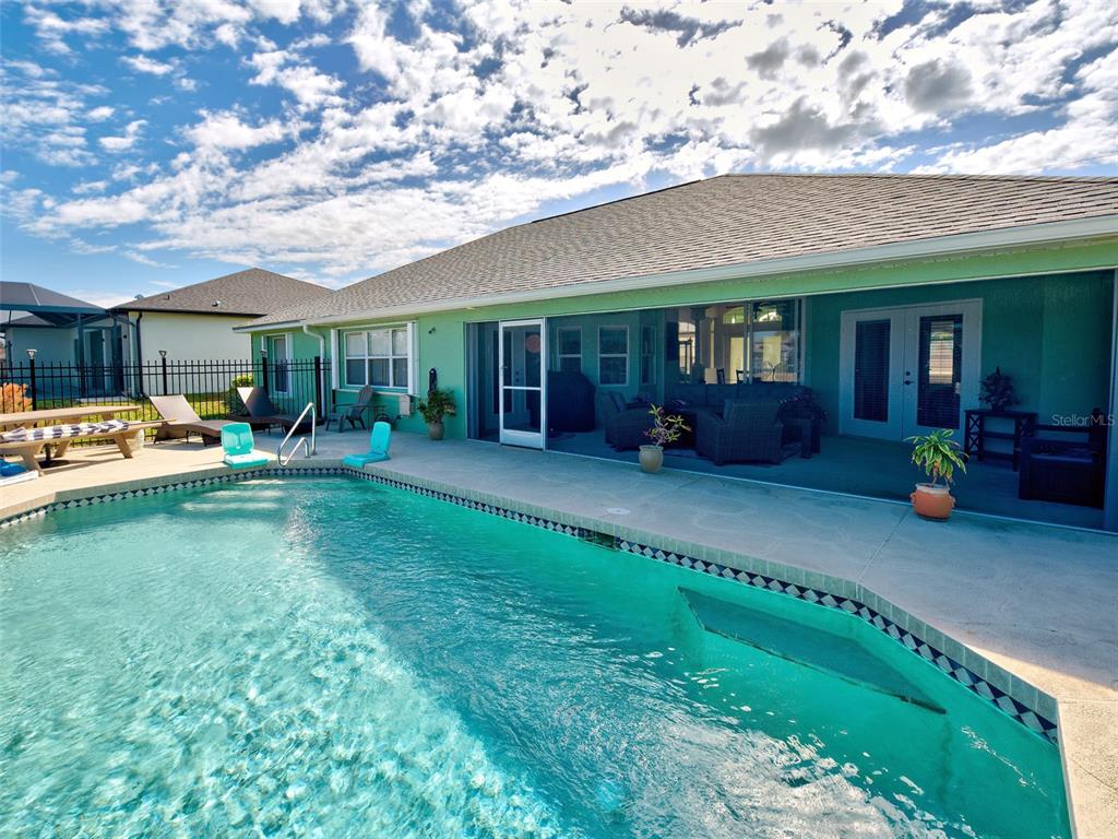 77 Medalist Road Rotonda West, FL 33947 - Photo 15 of 81 a view of a house with a backyard porch and sitting area