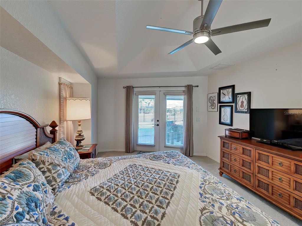 77 Medalist Road Rotonda West, FL 33947 - Photo 38 of 81 a bedroom with a bed and a flat screen tv