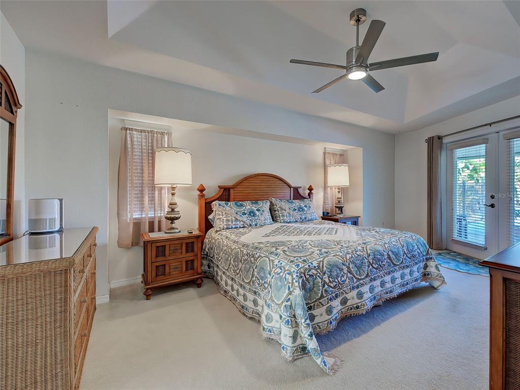 77 Medalist Road Rotonda West, FL 33947 - Photo 40 of 81 a bedroom with a bed chairs and dresser