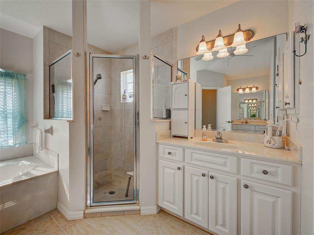 77 Medalist Road Rotonda West, FL 33947 - Photo 43 of 81 a bathroom with a double vanity sink mirror and shower