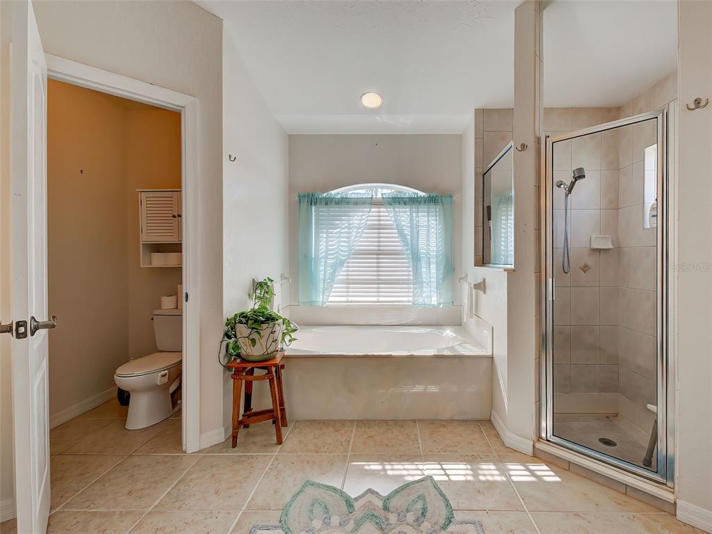 77 Medalist Road Rotonda West, FL 33947 - Photo 45 of 81 a bathroom with a bathtub and a shower