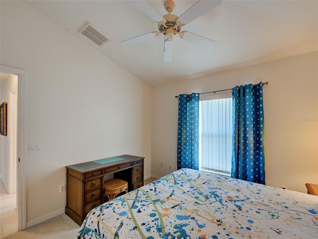 77 Medalist Road Rotonda West, FL 33947 - Photo 47 of 81 a bedroom with a bed dresser and a window