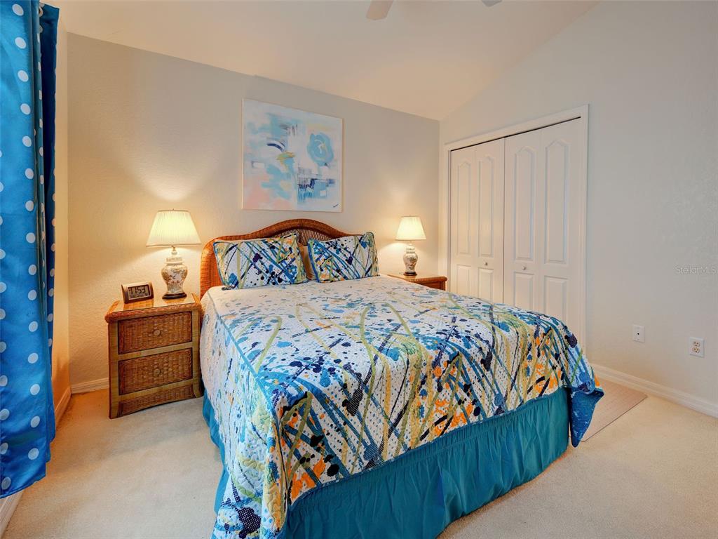 77 Medalist Road Rotonda West, FL 33947 - Photo 48 of 81 a bedroom with a bed and a painting on the wall