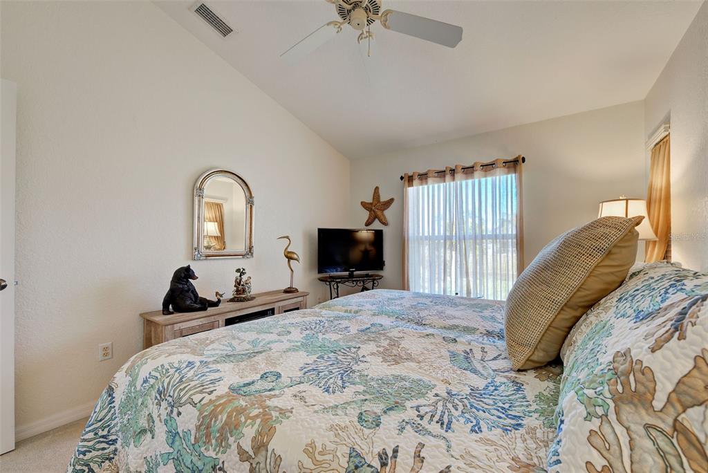 77 Medalist Road Rotonda West, FL 33947 - Photo 53 of 81 a bedroom with a bed and a tv