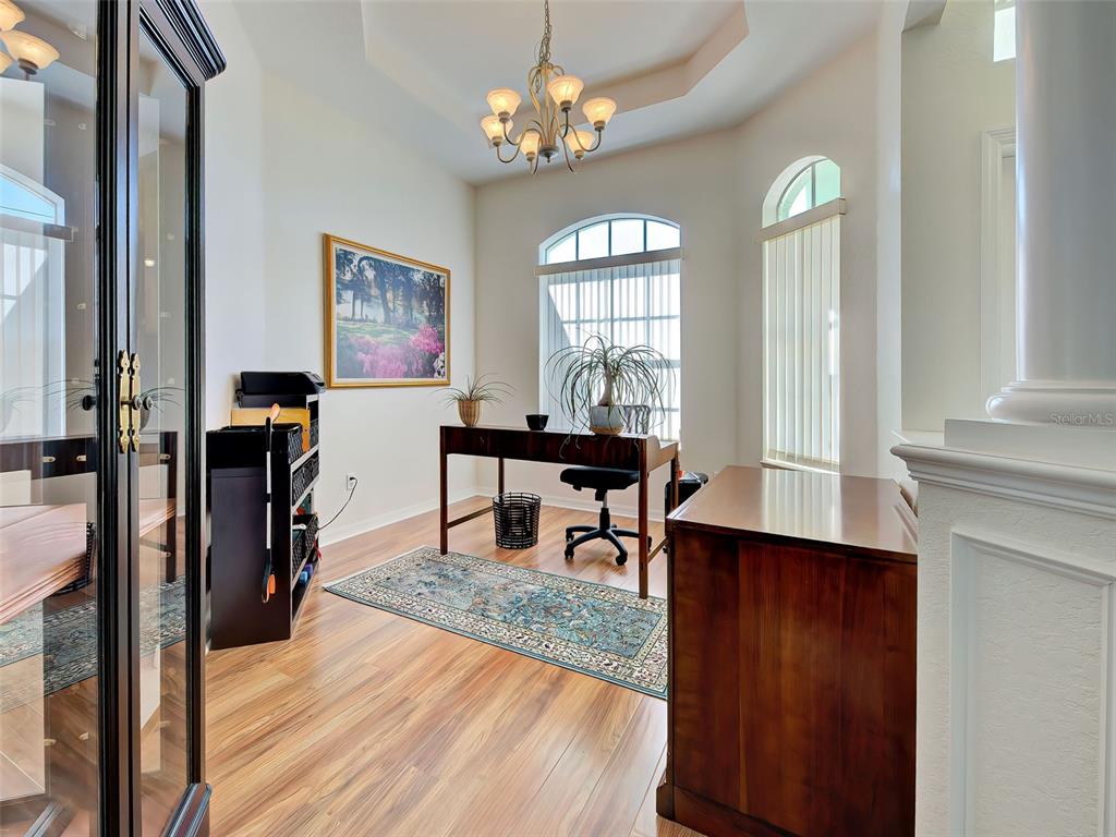 77 Medalist Road Rotonda West, FL 33947 - Photo 63 of 81 a view of a dining room with furniture and a chandelier