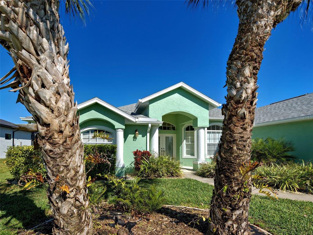 77 Medalist Road Rotonda West, FL 33947 - Photo 64 of 81 a front view of a house with garden