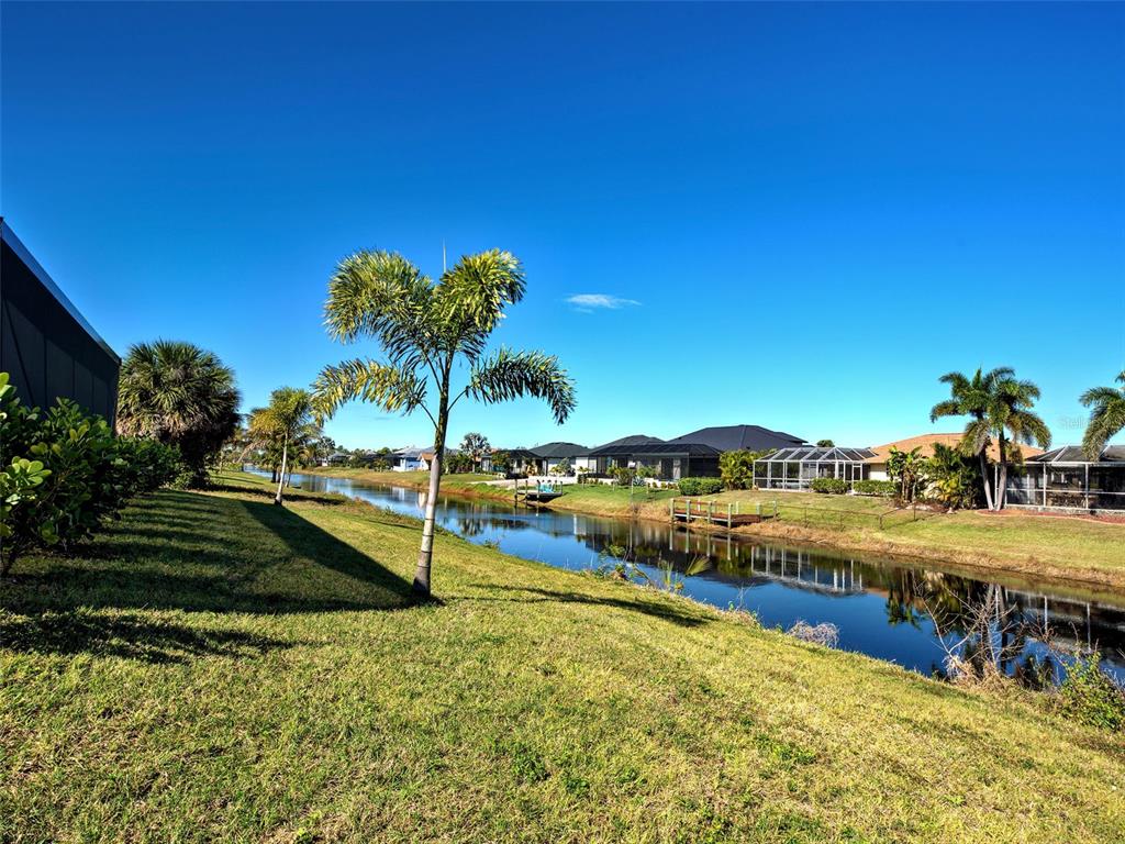 77 Medalist Road Rotonda West, FL 33947 - Photo 67 of 81 a view of a lake with a house in the background