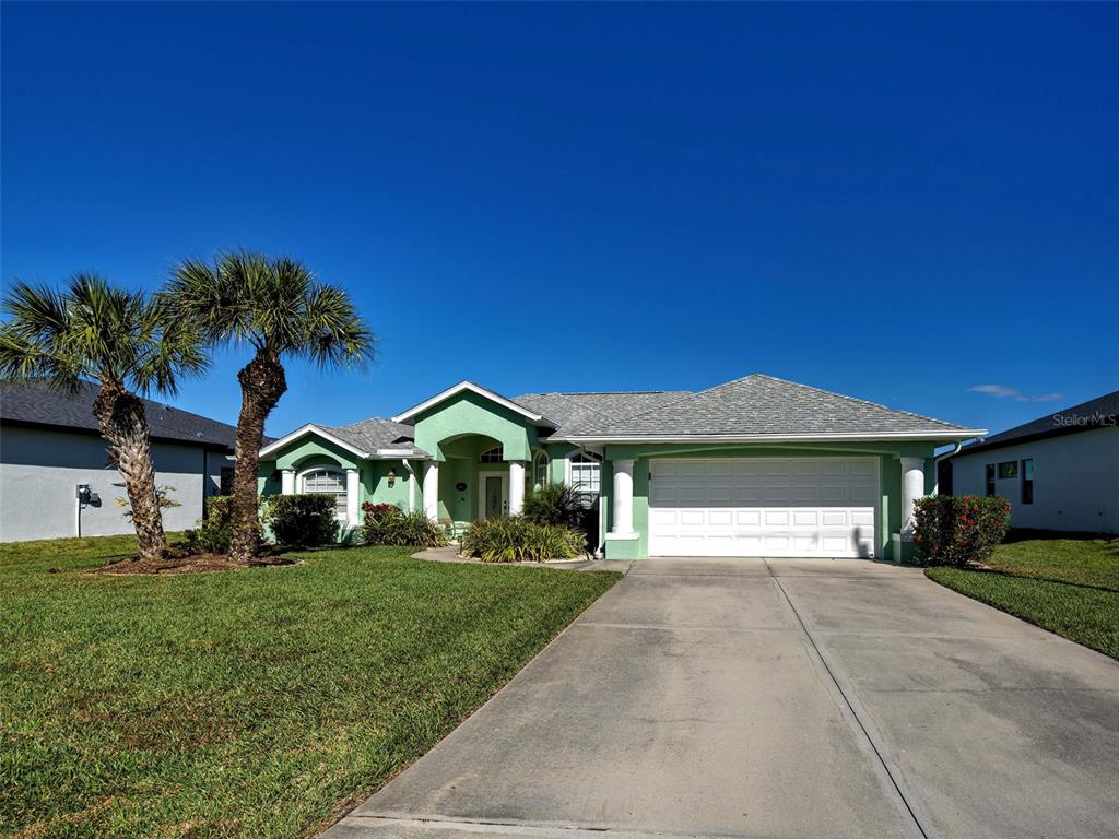 77 Medalist Road Rotonda West, FL 33947 - Photo 71 of 81 a front view of a house with a yard