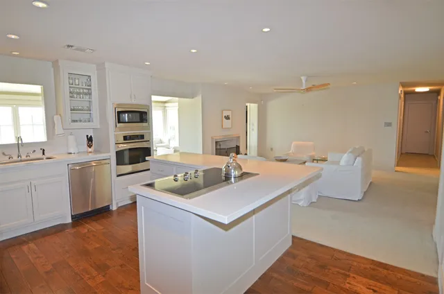 a kitchen with a sink stove and cabinets
