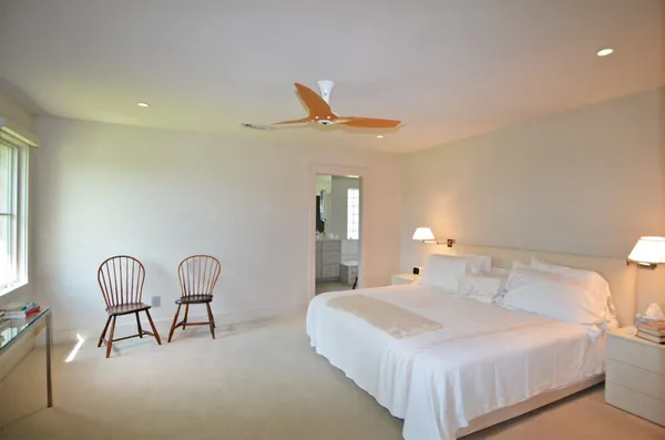a bedroom with a bed and chair