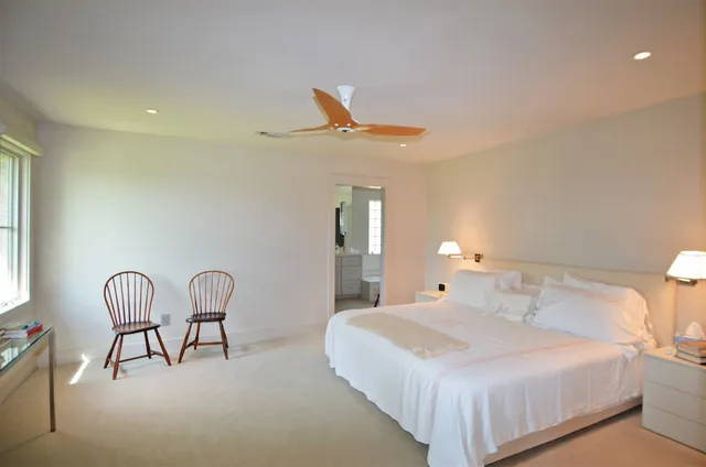 a bedroom with a bed and chair