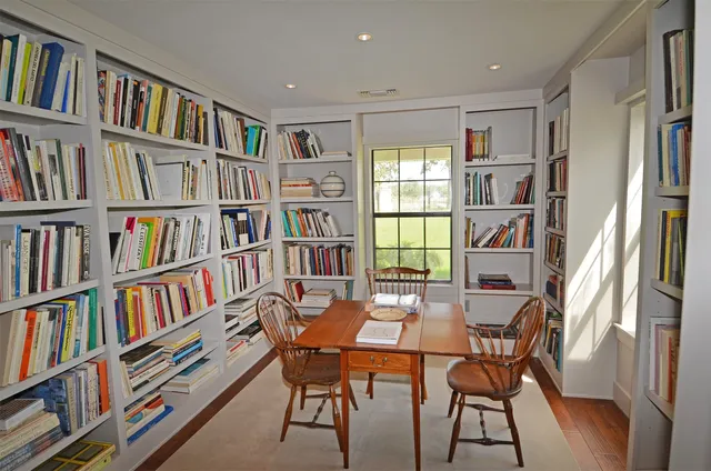 a dining room with furniture and a book shelf