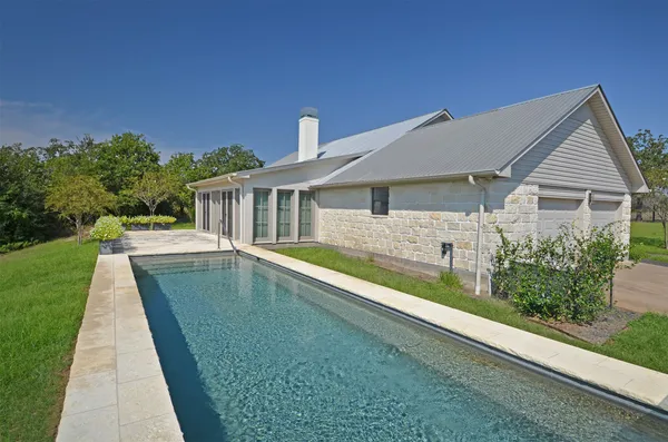 a house with swimming pool in front of it