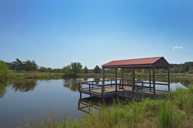 a swimming pool with outdoor seating and lake view