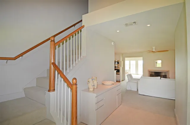 a view of a living room with white cabinets