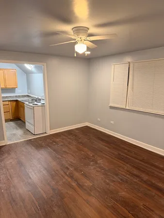 a view of a kitchen with a sink and dishwasher with wooden floor